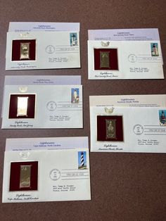 four envelopes with stamps on them sitting next to each other