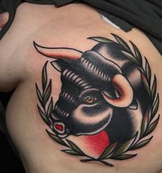 a bull tattoo on the back of a woman's stomach