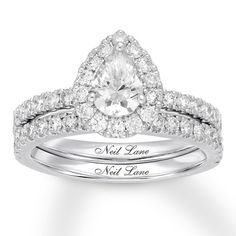 a wedding ring set with a pear shaped diamond