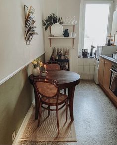 a table and chairs in a small kitchen