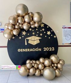 there is a graduation sign made out of gold balloons and stars on the top of it