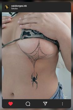 a woman with a spider tattoo on her stomach