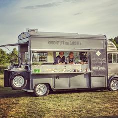 a food truck is parked on the grass