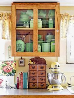 a kitchen counter topped with lots of green dishes