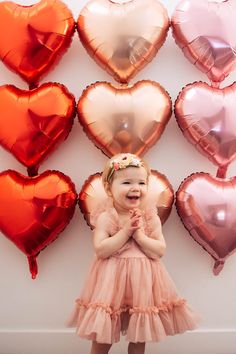 Baby girl wearing pink dress claps hands in front of heart balloon background. Toddler Valentine’s Day Photo Shoot, Valentines Photoshoot Backdrop, Valentine Kids Photoshoot Ideas, Siblings Valentines Photoshoot, Diy Valentines Photo Shoot Toddler, Valentines Diy Photoshoot, Valentines Day Toddler Photoshoot, Valentines Day Kids Photoshoot, Valentine’s Day Mini Session