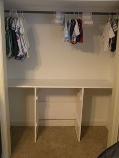 a closet with clothes hanging on hooks