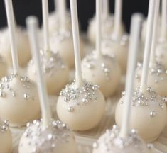 cake pops with white frosting and silver sprinkles