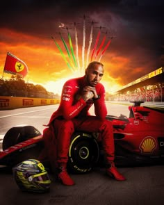 a man sitting on top of a red race car