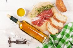 bread, olive oil and other ingredients on a white table