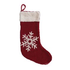 a red and white christmas stocking with snowflakes hanging from it's side