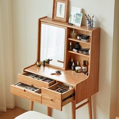 a wooden desk with drawers and a mirror