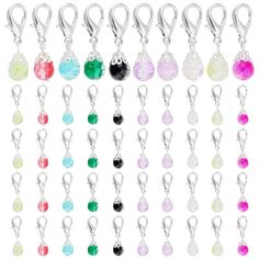 a bunch of charms with different colors and shapes on each one side, all hanging from the