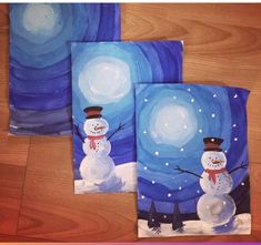 three paintings of snowmen are shown on a wooden surface with blue and white swirls in the background