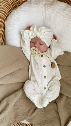 a baby is sleeping in a wicker basket