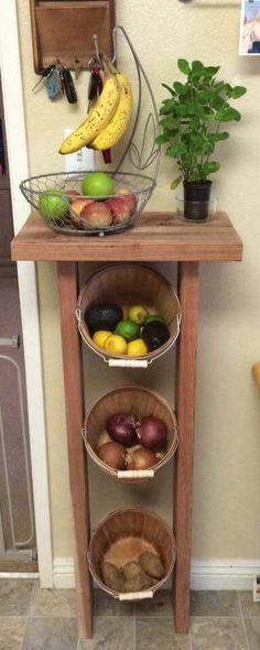 a wooden table topped with three baskets filled with fruit