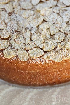 a cake covered in powdered sugar sitting on top of a table