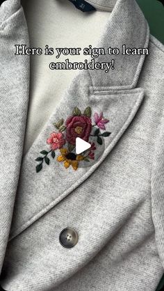 there is a jacket with flowers on it and the words here is your sign to learn embroidery