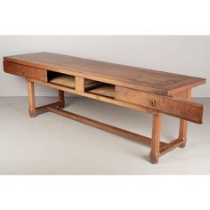 an old wooden table with two drawers on it