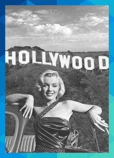 a woman leaning on the hood of a car with hollywood sign in the back ground