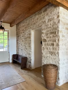 an empty room with stone walls and wood flooring is pictured in this image from the inside