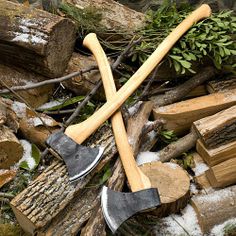 there are many different tools on the ground next to some rocks and wood pieces that have been chopped together