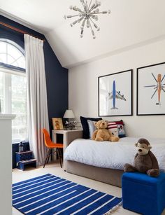 a bed room with a neatly made bed and a teddy bear