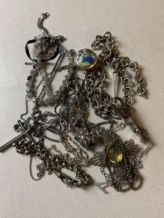 This is a 1/2 pound lot of broken and not, vintage and newer craft jewelry. The majority of these are wearable or for craft Silver tones There are necklaces, earrings, bracelets, key rings, broken pieces etc etc. Both vintage and modern. Perfect for your slow stitches or scrapbooking projects. Or other works of art This is NOT a mystery bag or box, so there will be no surprises You get everything in the picture. So study the pictures carefully !! Various materials such as plastic, metal, beads, Unique Metal Charms Jewelry, Silver Metal Jewelry For Accessorizing, Silver Metal Jewelry, Metal Charms Jewelry For Accessorizing, Costume Jewelry For Accessorizing, Vintage Metal Jewelry For Collectors, Collectible Round Costume Jewelry, Collectible Jewelry With Jewels, Ornate Metal Jewelry Collectible