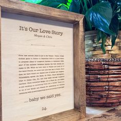 there is a wooden frame with a poem in it on the table next to some baskets