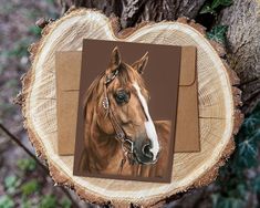 a brown and white horse standing on top of a wooden tree stump next to a piece of paper