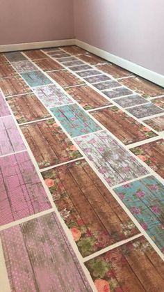 the floor is covered in patchwork and has been painted pink, blue, green and brown