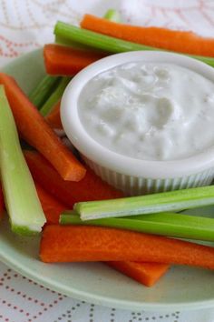 carrots, celery and celery sticks on a plate with dip