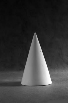 a white cone sitting on top of a floor