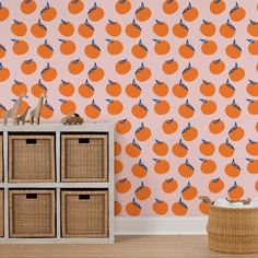 an orange wallpapered room with baskets on the floor and a basket next to it