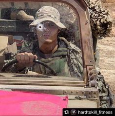 a man driving a pink truck with a large bird on it's face in the back