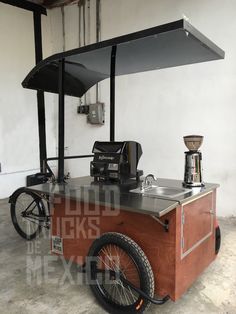 an old fashioned ice cream cart is parked in a garage with its wheels on the ground