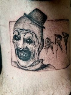 a man's neck with a creepy clown tattoo on his left side ribcage