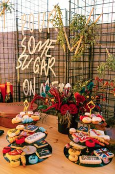 a table topped with lots of donuts covered in frosting