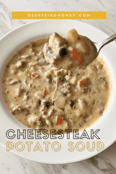 a bowl of cheese steak potato soup with a spoon in it on a white plate