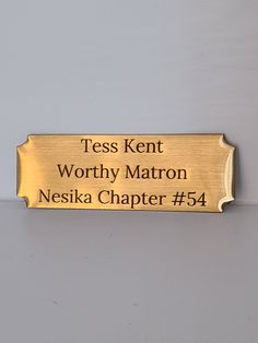 a brass plaque with the words, tess kent worthy matron and nesska charter 54