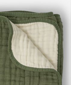 the green blanket is folded on top of it