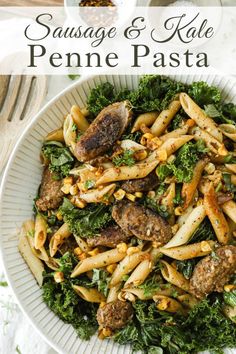 sausage and kale penne pasta in a white bowl