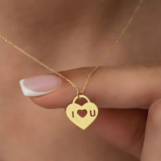 "This stunning 14K gold necklace is the perfect gift for your significant other.  The romantic padlock heart design symbolizes your love and commitment to each other, while the custom \"I Love You\" engraving adds a personal touch that will touch your soulmate's heart. Whether you're celebrating a special occasion or just want to show your love and appreciation, this necklace is an ideal gift that will make a lasting impression.  It comes in a beautiful gift box, making it a perfect present for Valentine's Day Gift Heart Necklace With Charms, Personalized Charm Necklace For Valentine's Day, Engraved Charm Necklaces For Her On Valentine's Day, Minimalist Charm Necklace For Valentine's Day, Engraved Charm Necklaces For Valentine's Day, Engraved Charm Necklace For Valentine's Day, Meaningful Heart Charm Necklaces For Valentine's Day, Heart-shaped Charm Necklace For Mother's Day, Meaningful Heart Charm Necklace For Valentine's Day