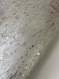 a close up view of the surface of a bed with white sheets and brown stains on it