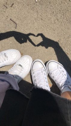 two people standing next to each other with white shoes