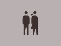 two people standing next to each other on a gray background