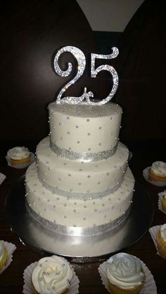 a wedding cake and cupcakes on a table with the number twenty fifty five