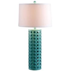 a green table lamp with a white shade on the top and an oval shaped base