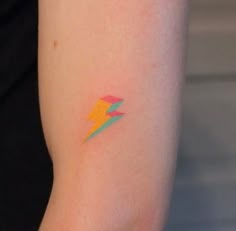 a woman's arm with a colorful tattoo on the left side of her arm