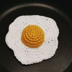 an egg in a frying pan with a crochet pattern