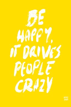 the words be happy, it drives people crazy are painted in white on a yellow background